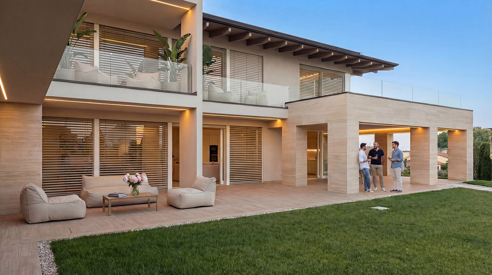 Villa L|J vista dal giardino nella luce della sera, con il portico abitato